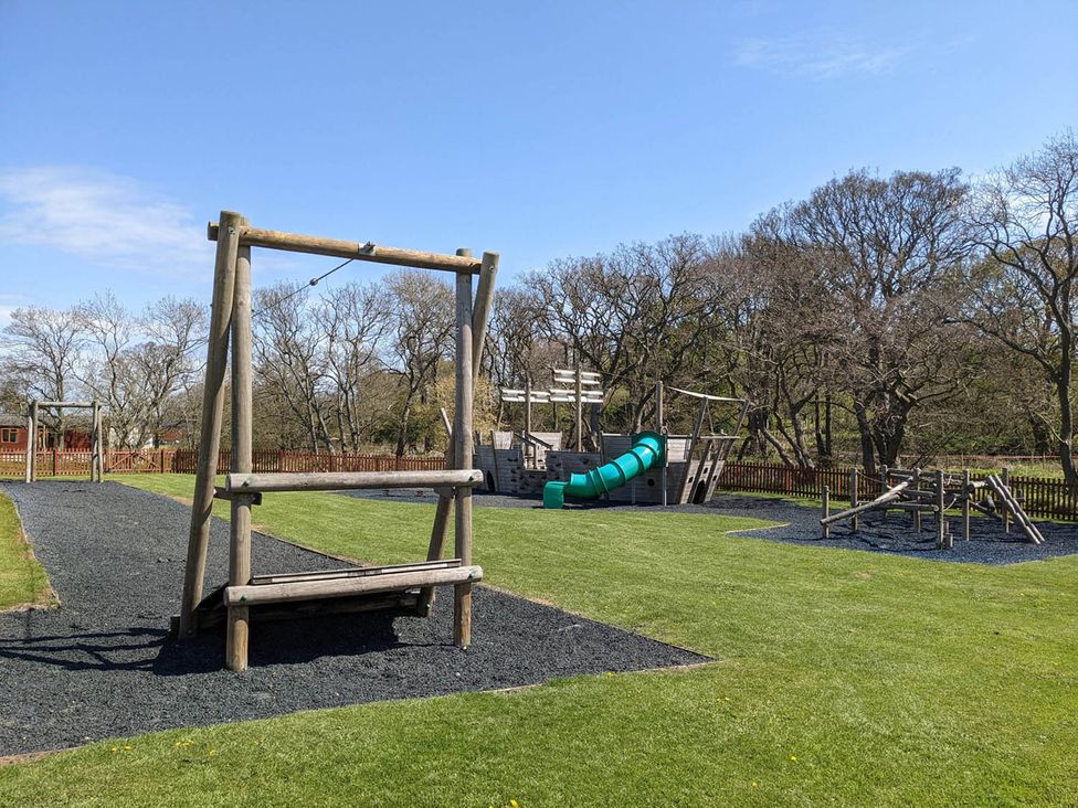 A playground with a swing and slide at Felmoor Park near Felton
