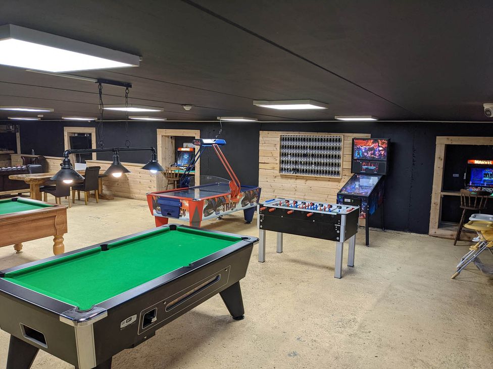 A game room with a pool table and arcade games at Felmoor Park Northumberland Lodge with Hot Tub in Felmoor Park near Felton
