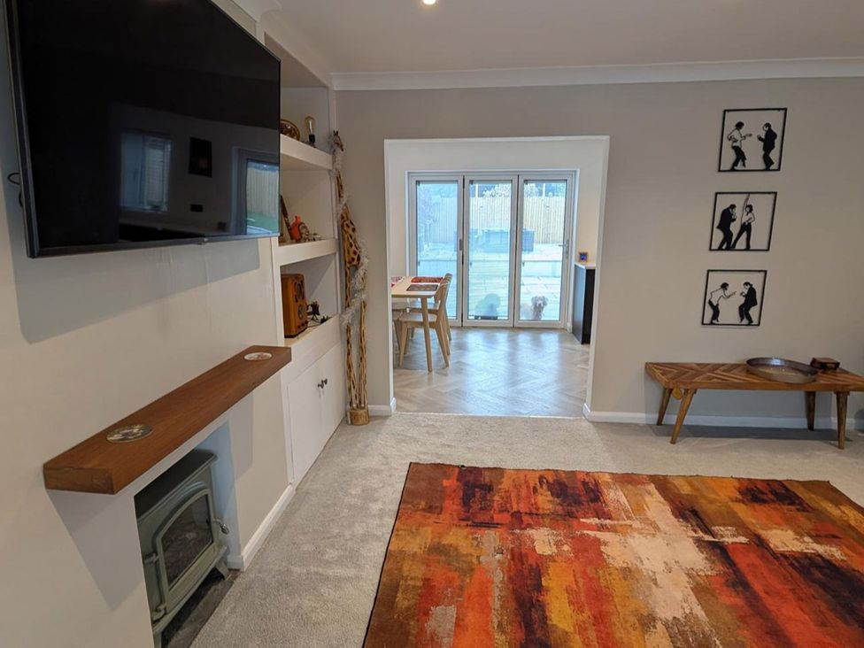A living room with a television and shelves at 3 Bed Sleeps 5 Garden Parking Pets in Carlisle