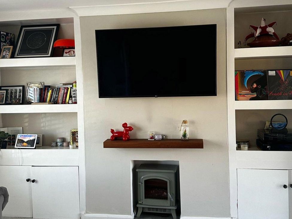 A living room with a television above a fireplace at 3 Bed Sleeps 5 Garden Parking Pets in Carlisle