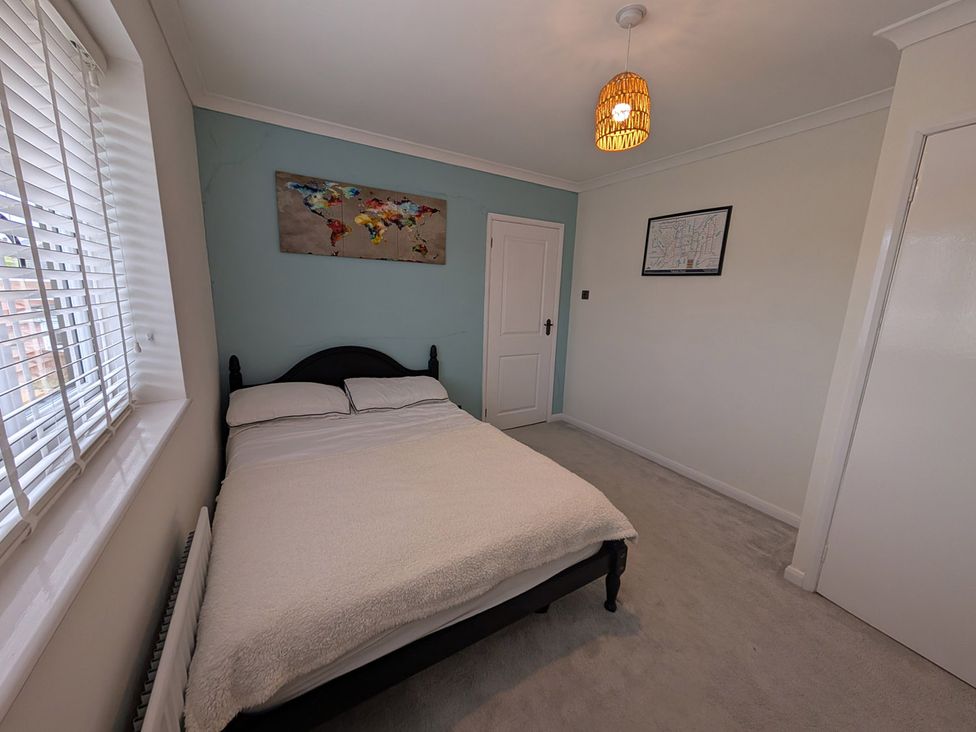 A bedroom with a bed and wall map at 3 Bed Sleeps 5 Garden Parking Pets in Carlisle