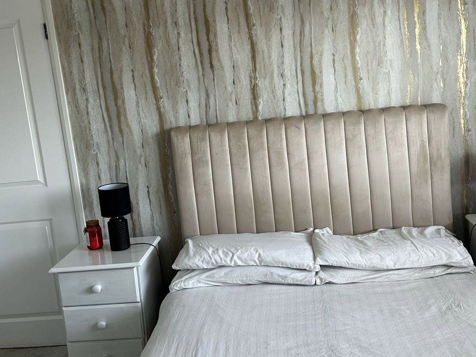 A bedroom with a bed, headboard, nightstand, and lamp at 3 Bed Sleeps 5 Garden Parking Pets in Carlisle