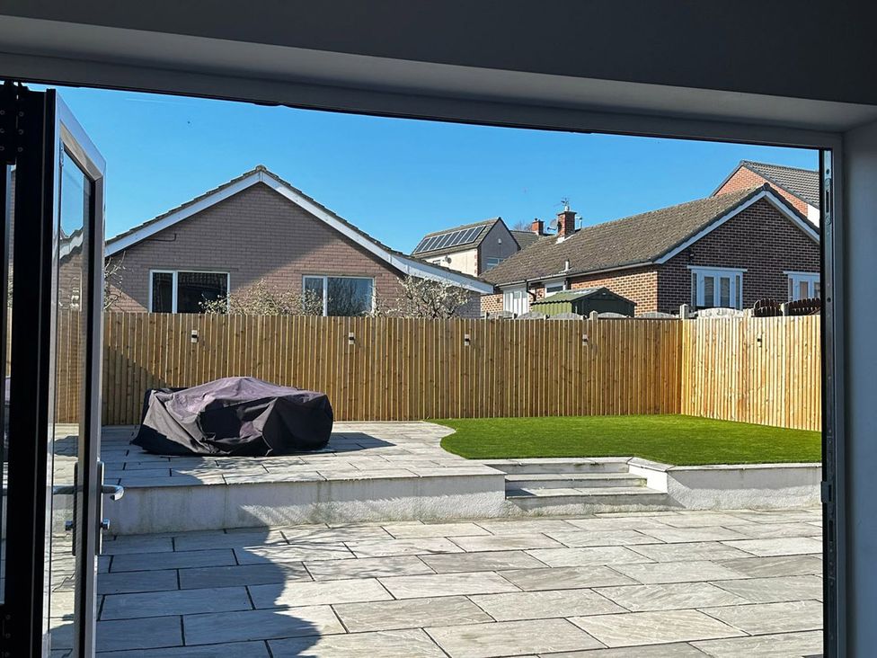 A garden view with patio furniture and a fence at 3 Bed Sleeps 5 Garden Parking Pets Carlisle