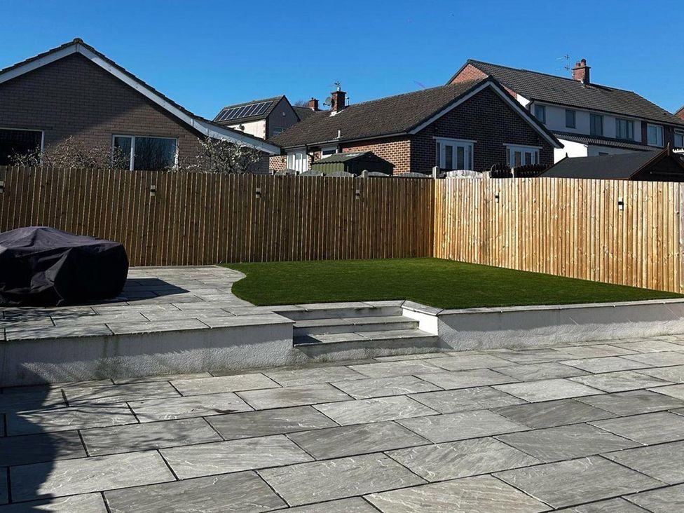 A garden with a patio and steps at 3 Bed Sleeps 5 Garden Parking Pets in Carlisle
