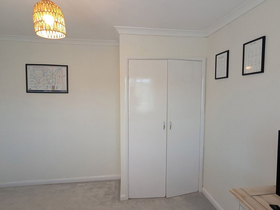 A living room with a wardrobe and a map on the wall at 3 Bed Sleeps 5 Garden Parking Pets in Carlisle
