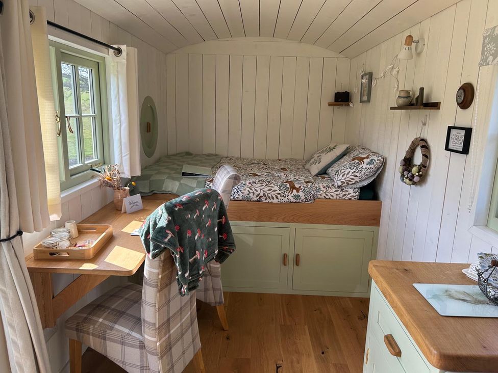 A bedroom with a bed and desk at 