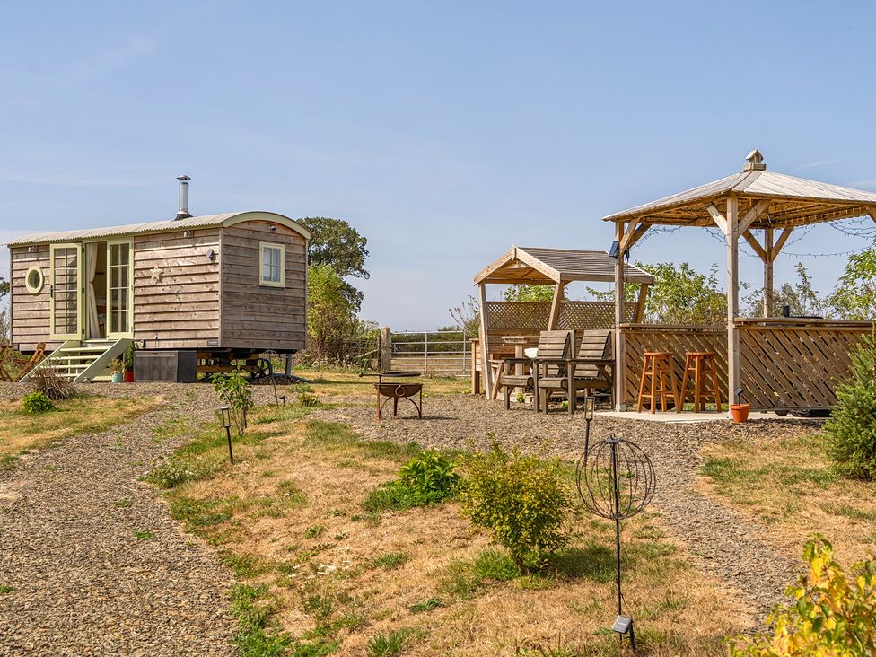An outdoor area with a tiny house and gazebo at Cosy Luxury Owls Roost Hut with Private Hot Tub Little Deptford Farm near Umberleigh