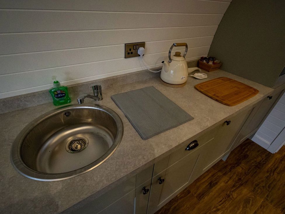 A kitchen with a sink and kettle at 1Bed pod cabin in beautiful surroundings Wrexham