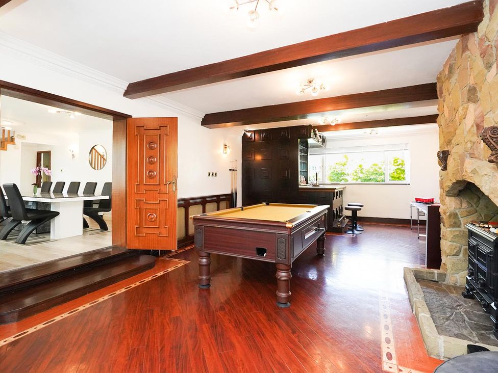 A game room with a pool table and a fireplace at RentMySpaHome with Swimming Pool Hot Tub and Sauna in Aughton
