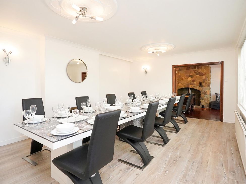A dining room with a large table set for dinner at RentMySpaHome with Swimming Pool Hot Tub and Sauna Aughton