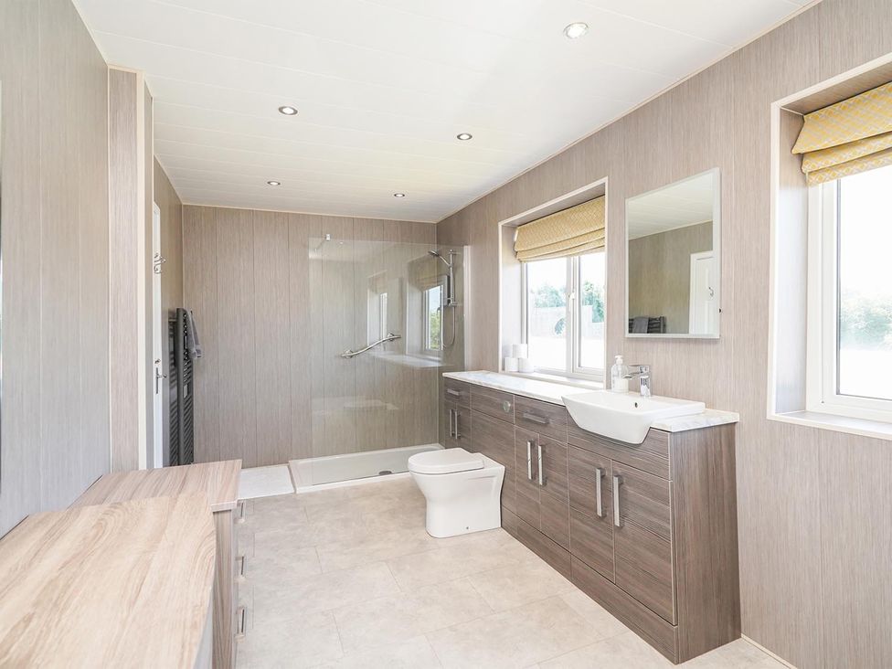 A bathroom with a shower, toilet, and sink at RentMySpaHome with Swimming Pool Hot Tub and Sauna Aughton