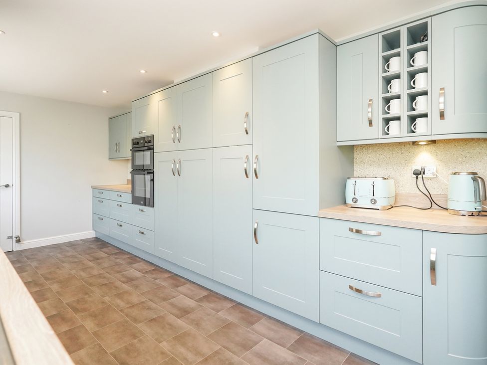 A kitchen with cabinets, oven, and countertop at RentMySpaHome with Swimming Pool Hot Tub and Sauna Aughton
