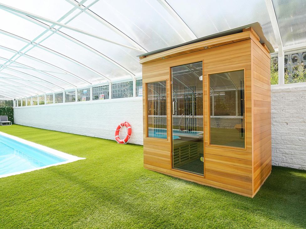 A sauna next to a swimming pool at RentMySpaHome with Swimming Pool Hot Tub and Sauna Aughton