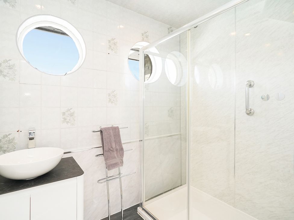 A bathroom with a sink and shower at RentMySpaHome with Swimming Pool Hot Tub and Sauna in Aughton