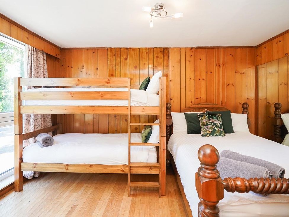 A bedroom with a bunk bed and a double bed at RentMySpaHome with Swimming Pool Hot Tub and Sauna in Aughton