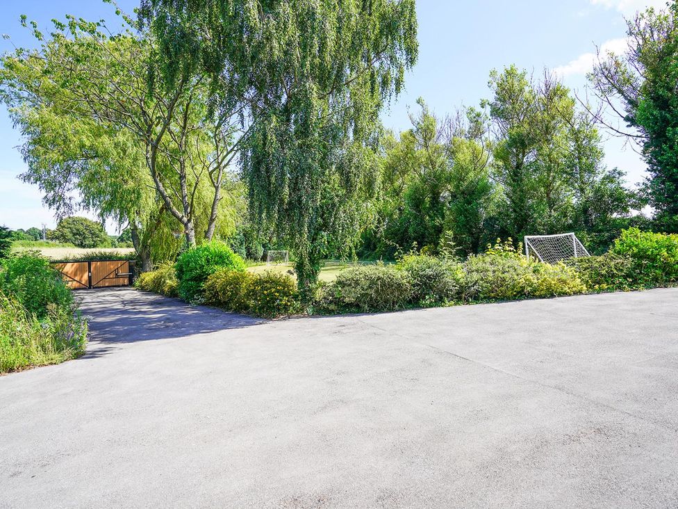 A driveway with gate and trees at RentMySpaHome with Swimming Pool Hot Tub and Sauna Aughton
