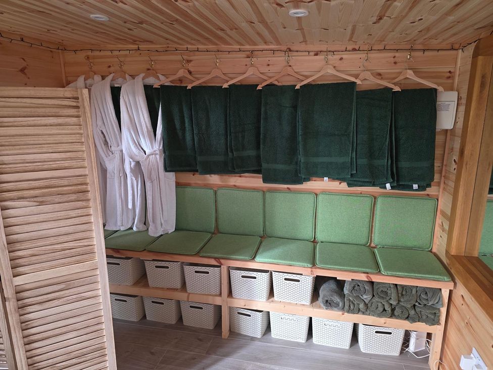 A spa area with robes, towels, and storage baskets at RentMySpaHome with Swimming Pool Hot Tub and Sauna Aughton