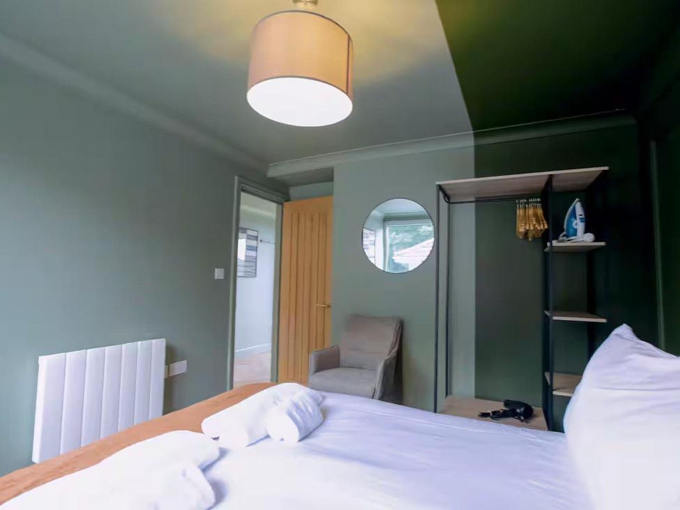 A bedroom with a bed and shelf at 1 Bedroom Apartment Sleeps 2 Pets Welcome Carbis Bay