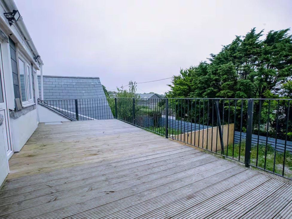 A deck with railing and trees at 1 Bedroom Apartment Sleeps 2 Pets Welcome Carbis Bay