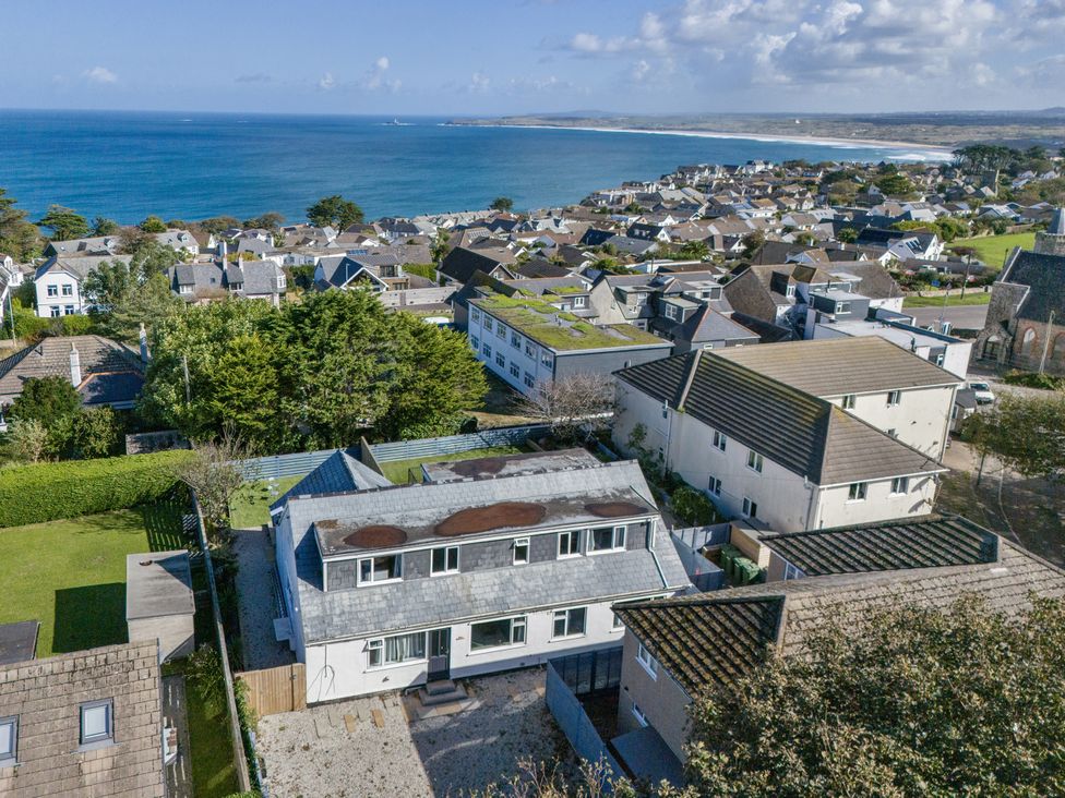 An aerial view of houses with ocean in the background at 1 Bedroom Apartment Sleeps 2 Pets Welcome, Carbis Bay