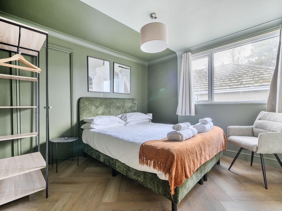 A bedroom with a bed and chair at 1 Bedroom Apartment Sleeps 2 Pets Welcome in Carbis Bay