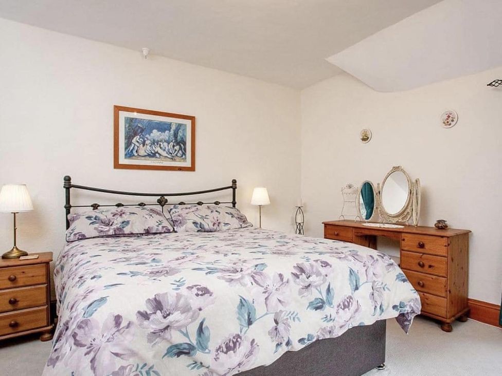 A bedroom with a bed and a dresser at the property in the location