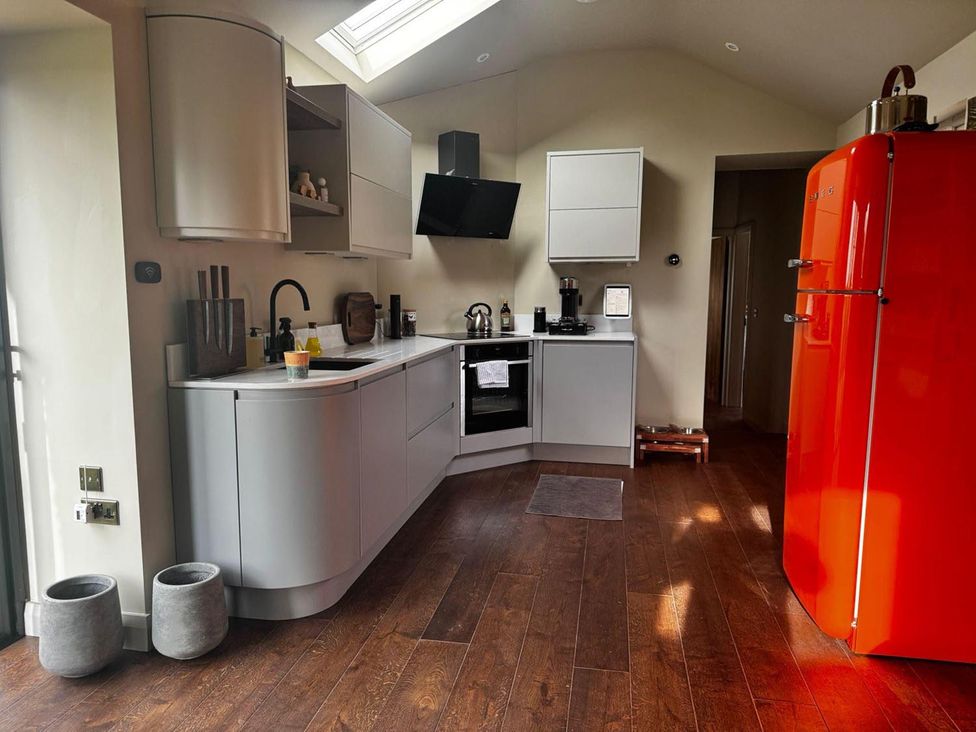 A kitchen with modern appliances and light cabinetry at 