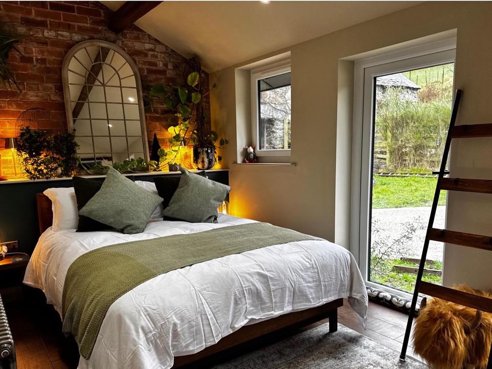 A bedroom with a bed and plants at a property in an unknown location