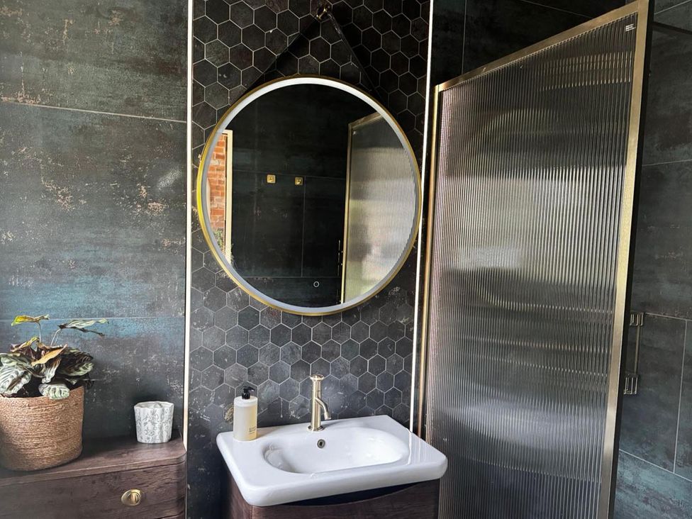 A bathroom with a sink and shower at 