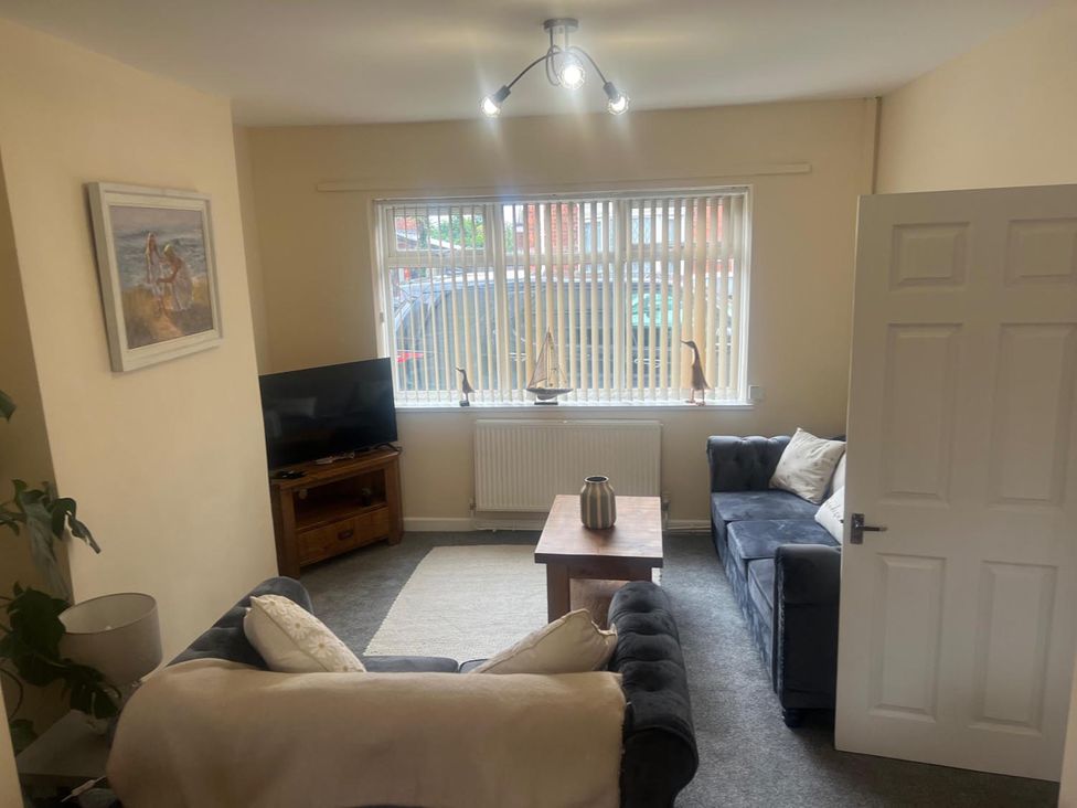 A living room with a television and sofa at the property in the location