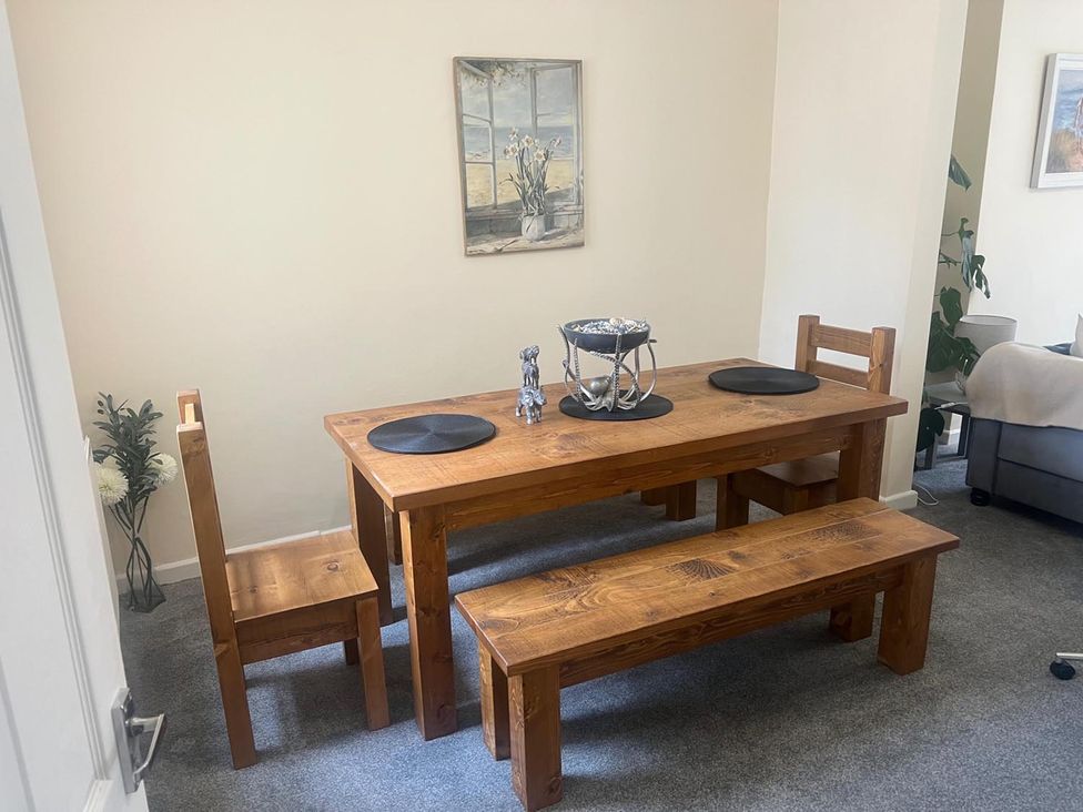 A dining room with a wooden table and chairs at The Old Barn in Manchester