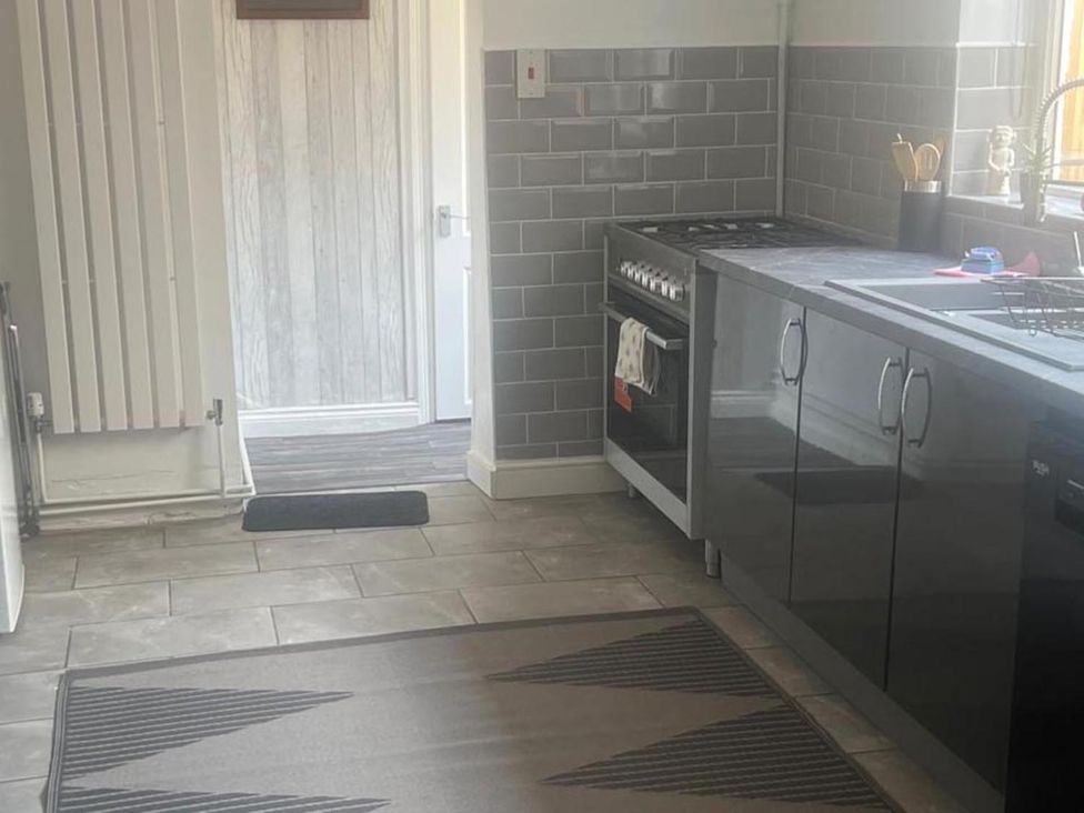 A kitchen with an oven and countertop at the property in the location