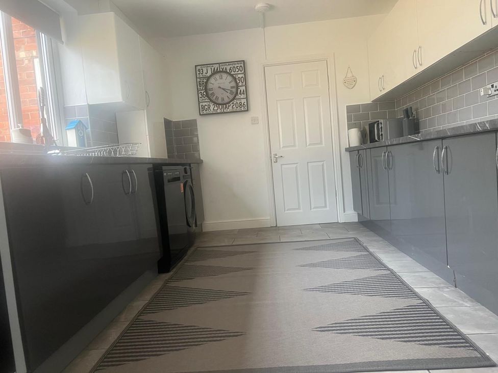 A kitchen with appliances and cabinets at The Old Barn in Manchester
