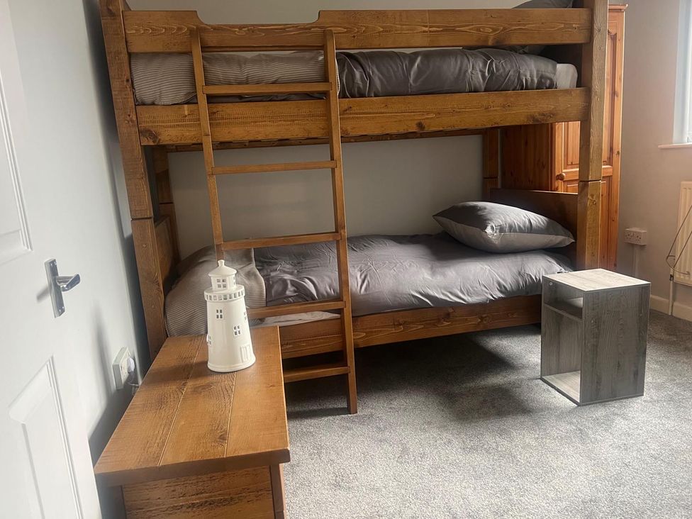 A bedroom with a bunk bed and nightstand at the property