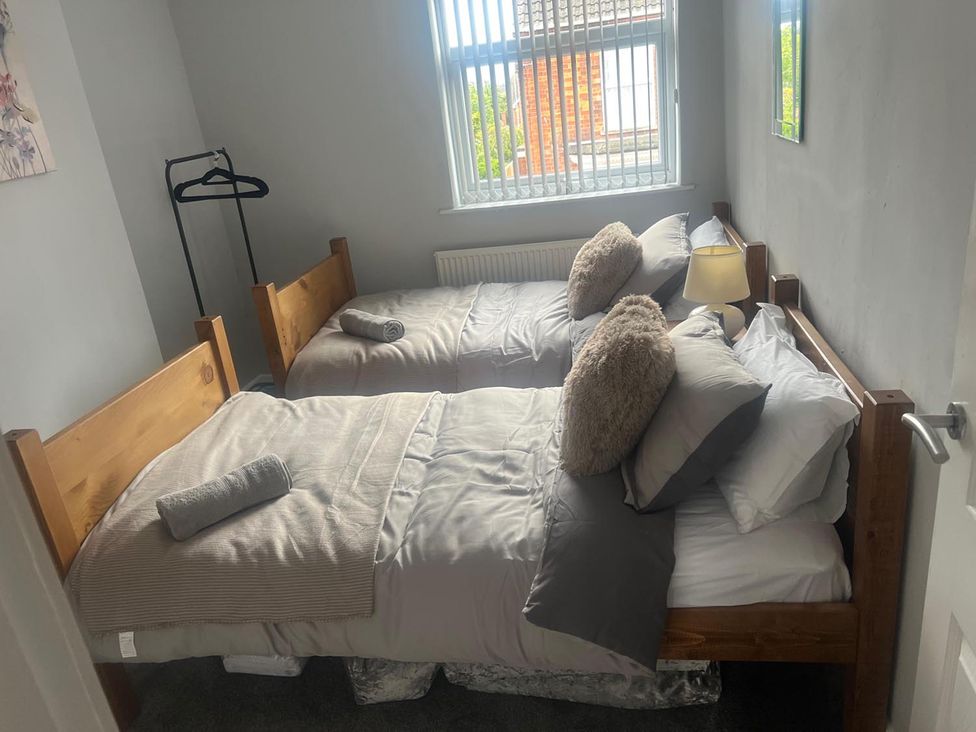 A bedroom with two beds and a lamp at the property