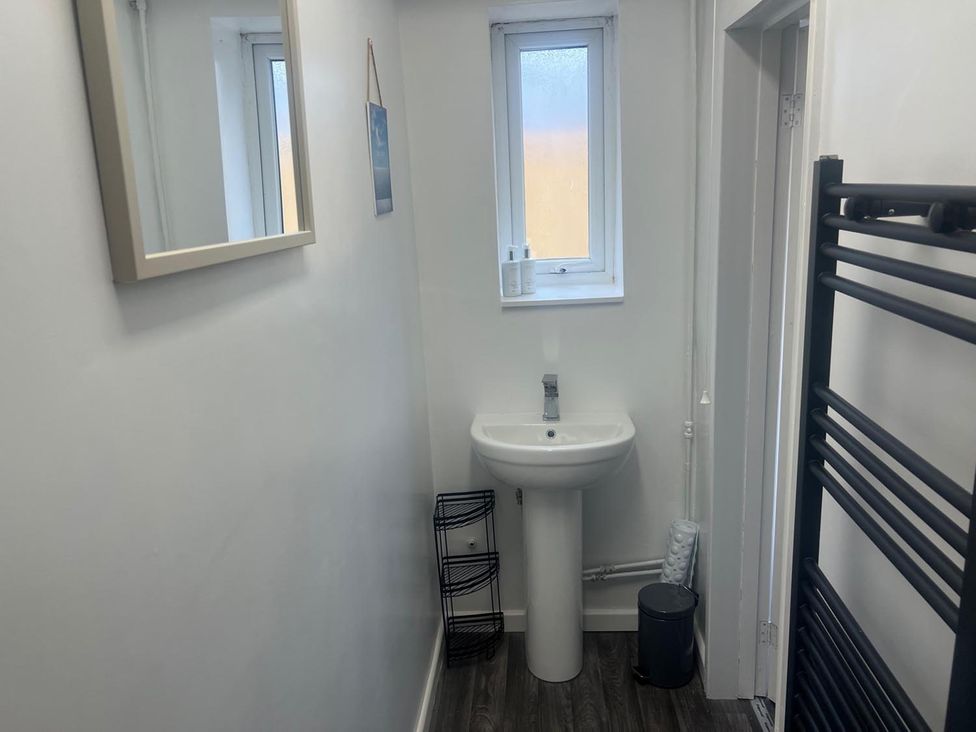 A bathroom with a sink and mirror at The Old Barn in Manchester