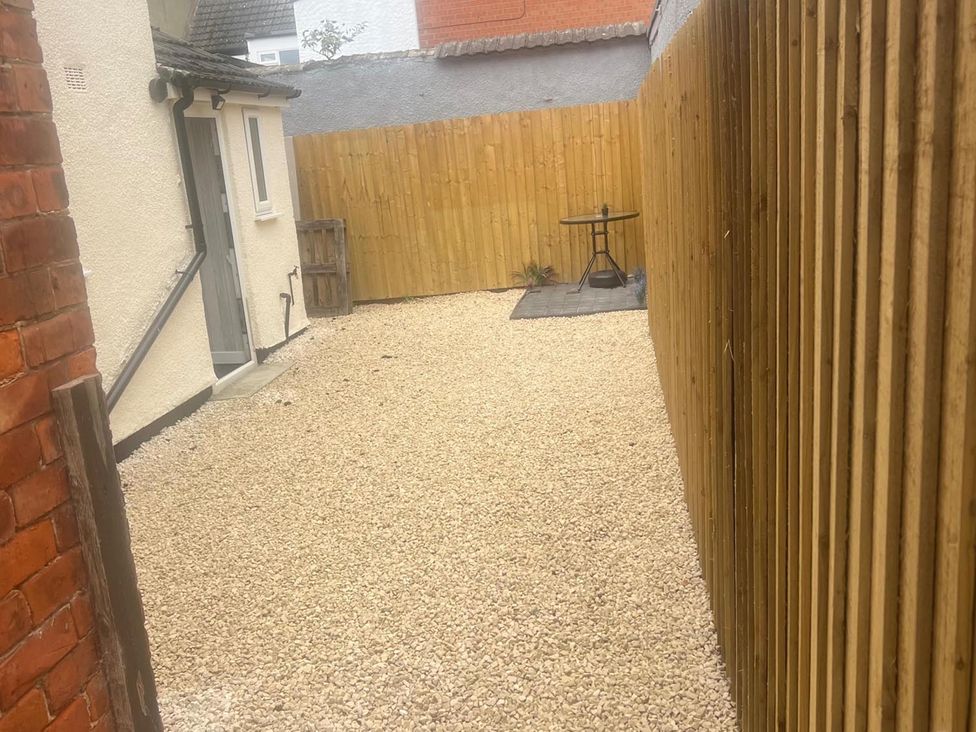 A garden with gravel and a table and chair at the property