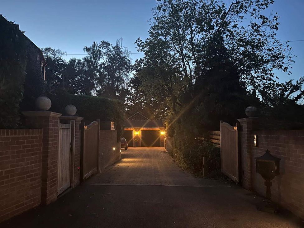 A driveway with a gate and garage at the property