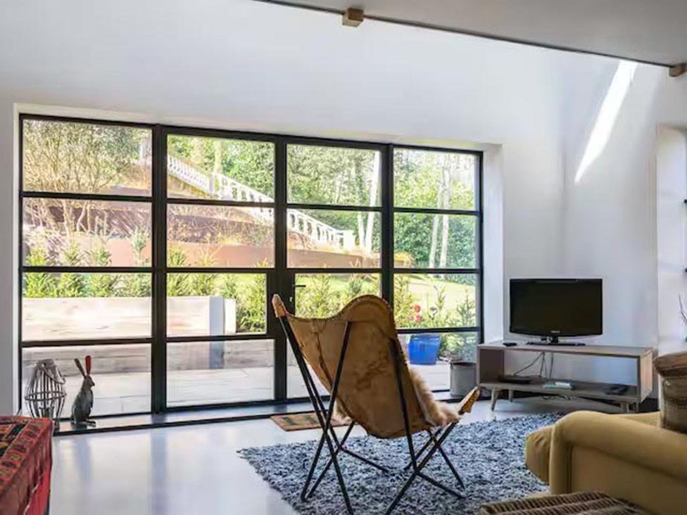 A living room with a window and a television at the property