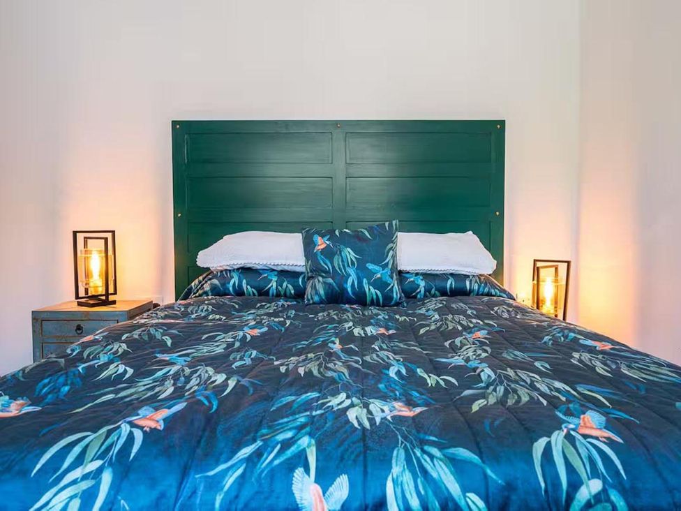 A bedroom with a bed, pillows, and lamps at The Old Barn in Manchester
