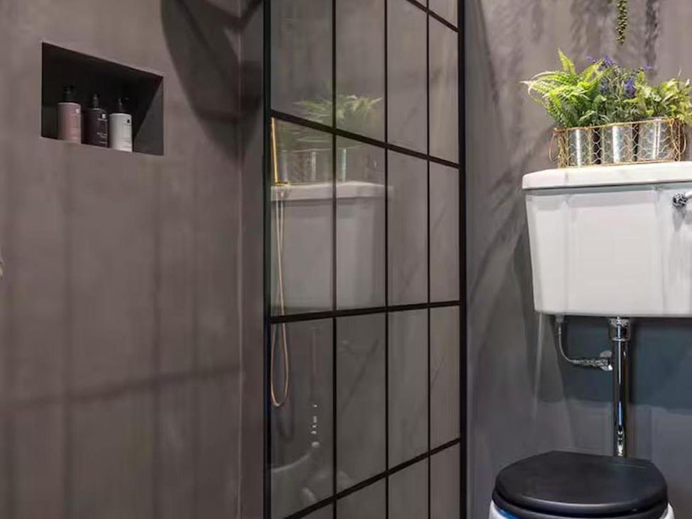 A bathroom with a shower and toilet at 