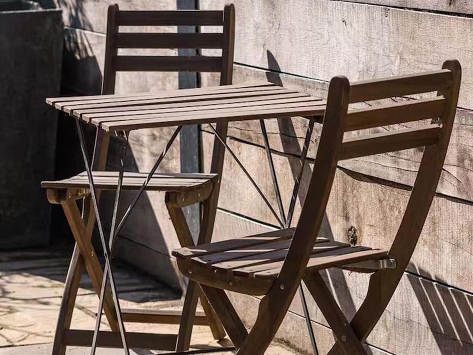 A table and two chairs on a patio at the property