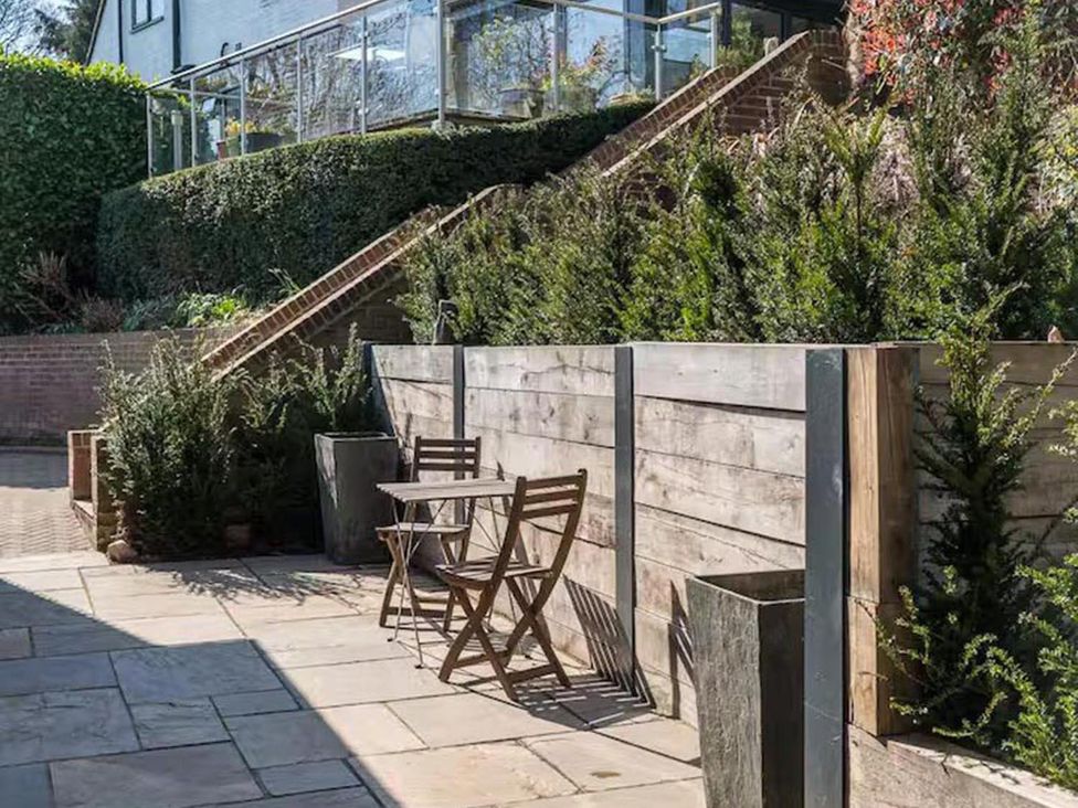 A garden with a table and chairs and planters at 