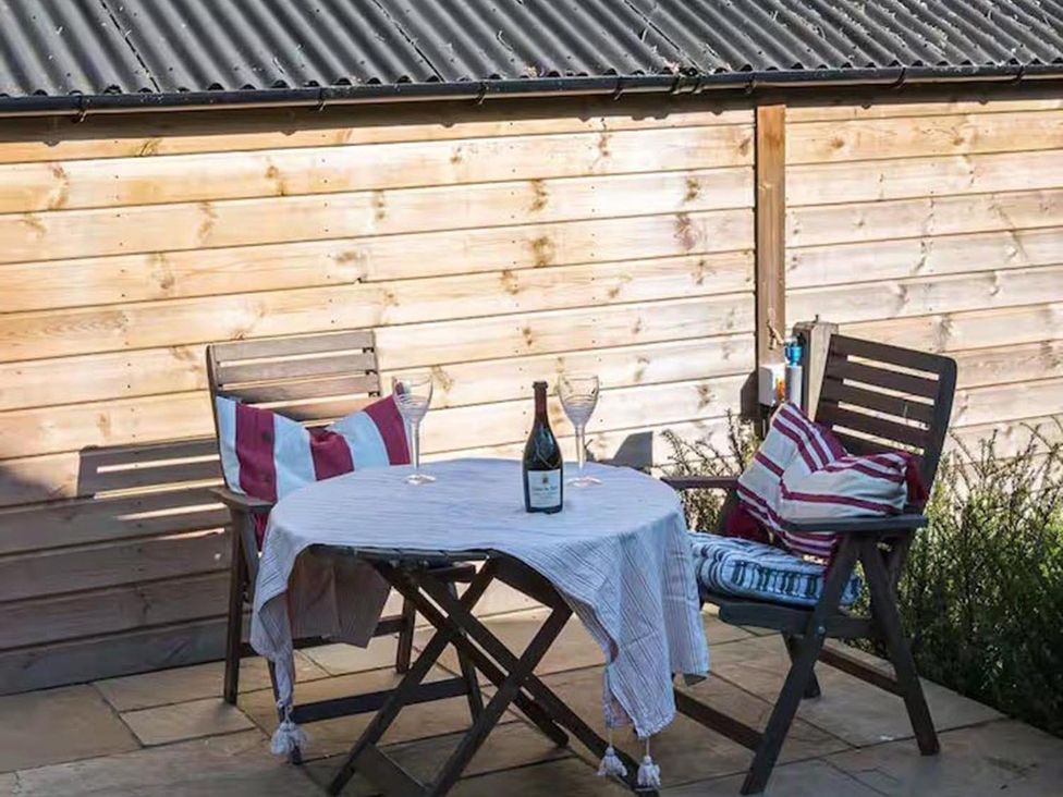 An outdoor seating area with a table and chairs at an unspecified location