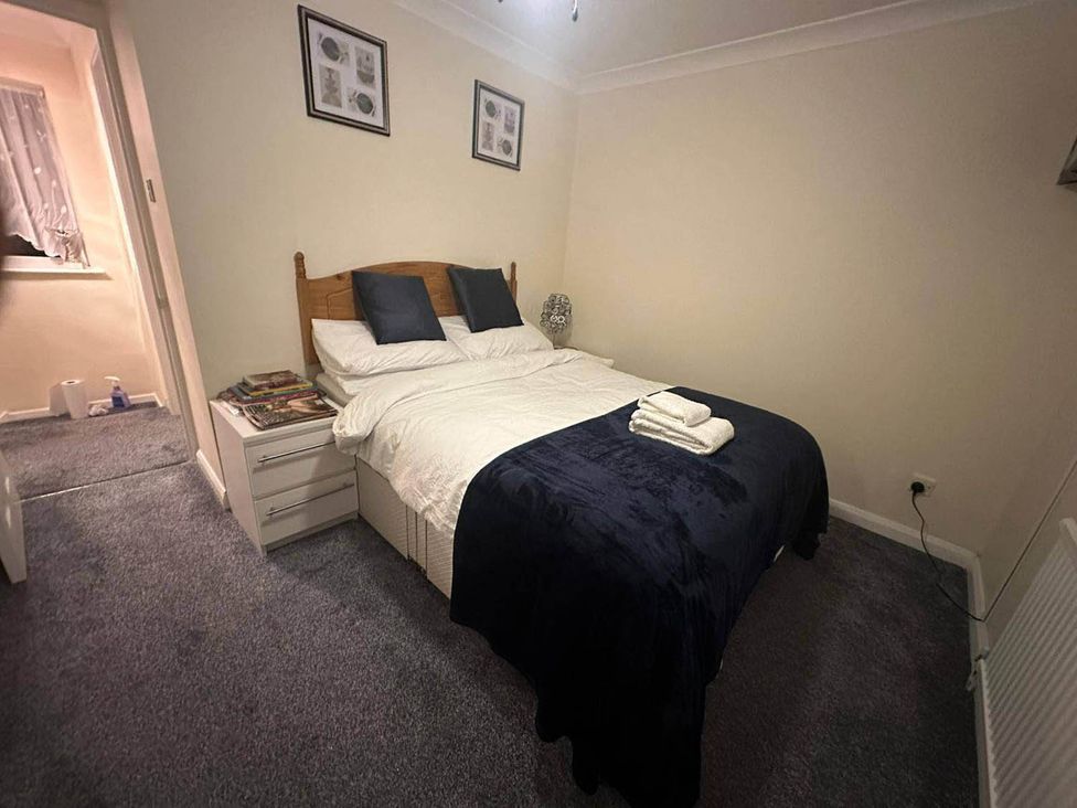 A bedroom with a bed and nightstand at 4 Bed House Sleeps 8 Pets Parking Wifi