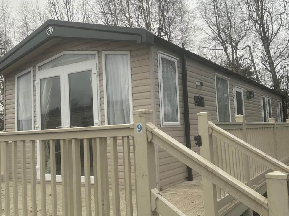 A caravan with a deck and steps at Charming Caravan in beautiful Seton Sands Cockenzie And Port Seton