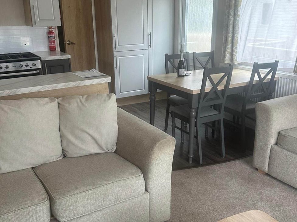 A living room with sofa and dining area at Charming Caravan in beautiful Seton Sands Cockenzie And Port Seton