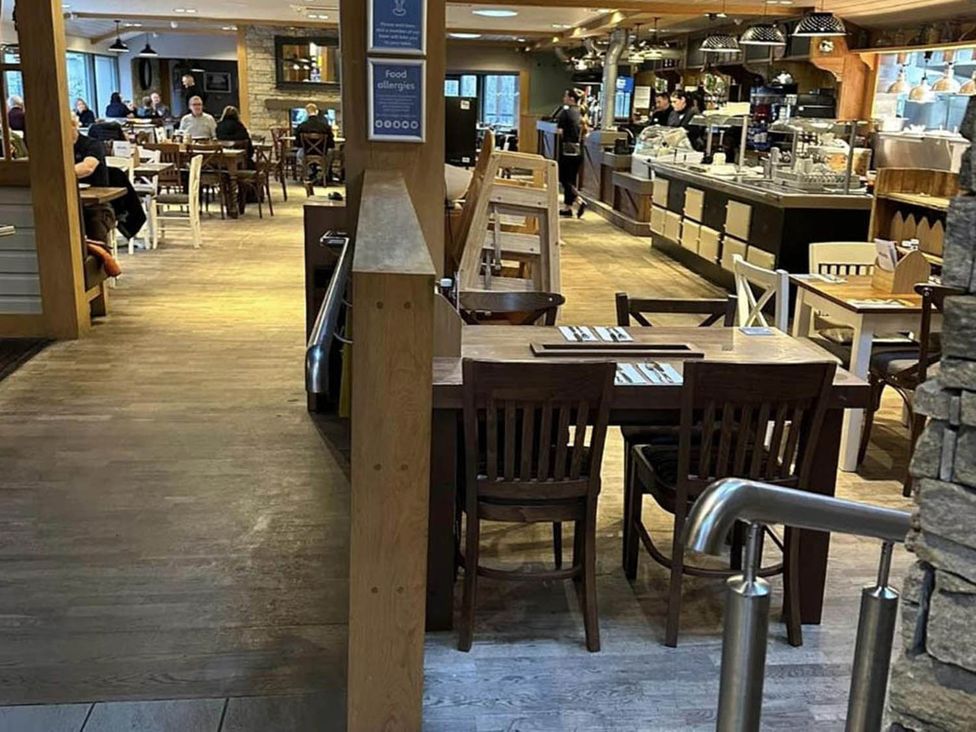 A dining area with wooden tables and chairs at Charming Caravan in beautiful Seton Sands, Cockenzie And Port Seton