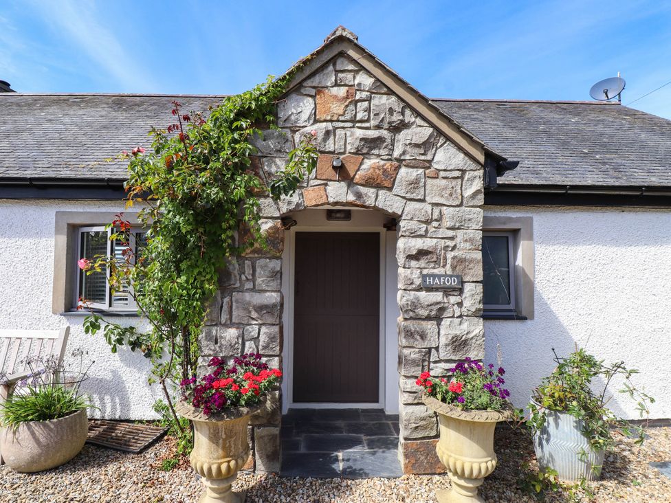 An entrance with stone wall and planters at Hafod in Nefyn