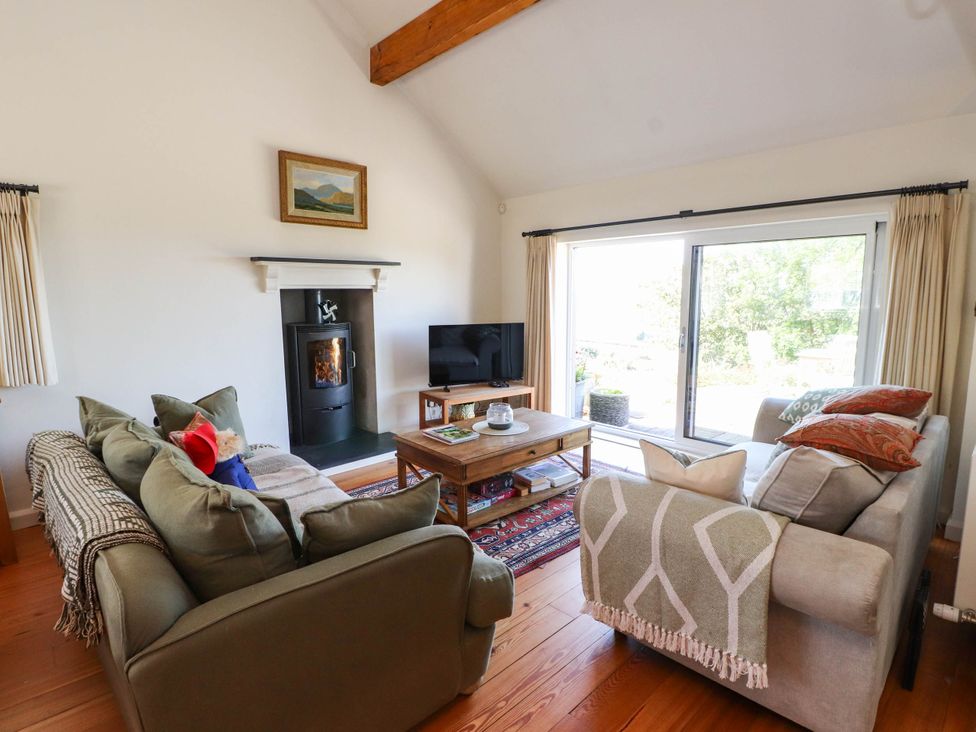 A living room with a sofa and coffee table at Hafod in Nefyn